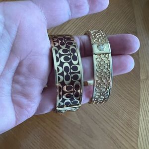 Two gold COACH bracelets. Size 7. One is a brownish burgundy color.